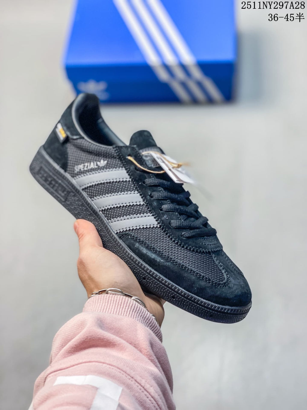 Black Adidas Spezial-style sneaker with gray stripes and dark outsole