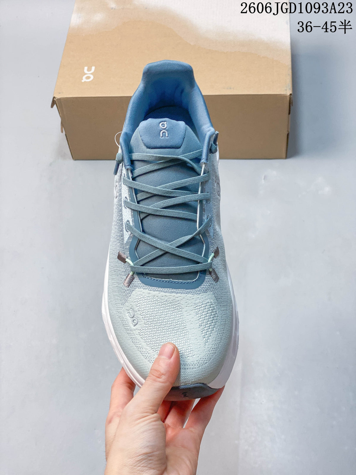 Front view showing the laces, tongue and pale blue upper