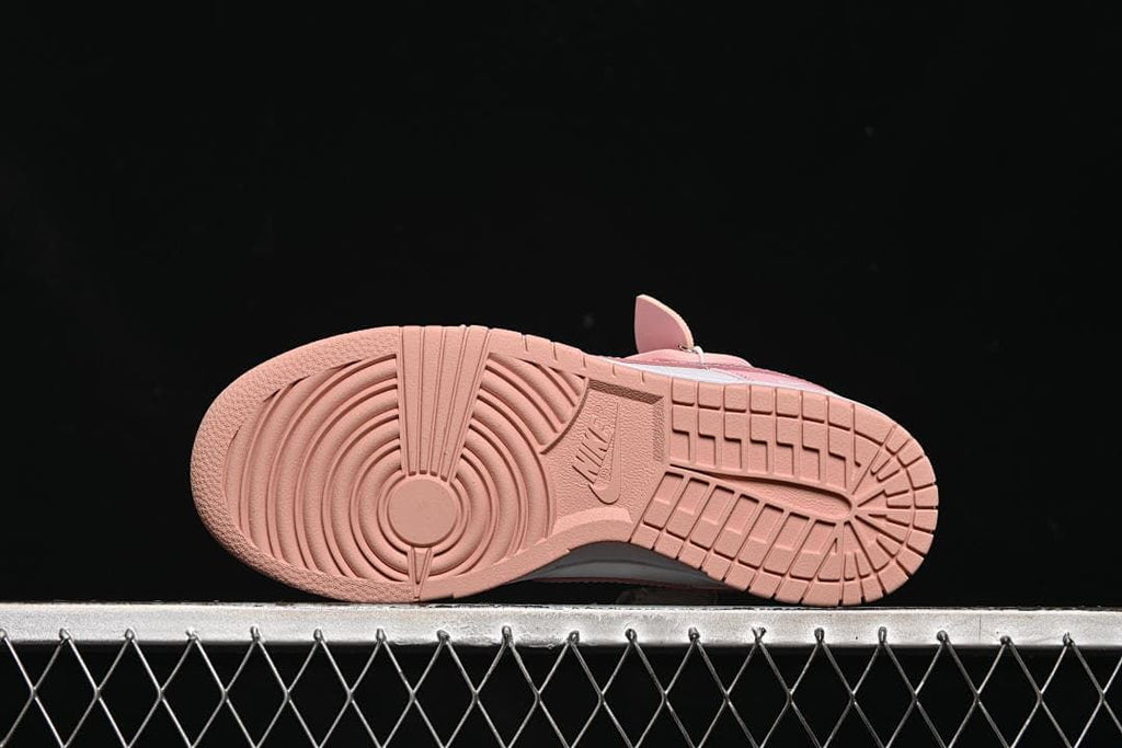 Pink rubber outsole with circular forefoot and tread pattern.
