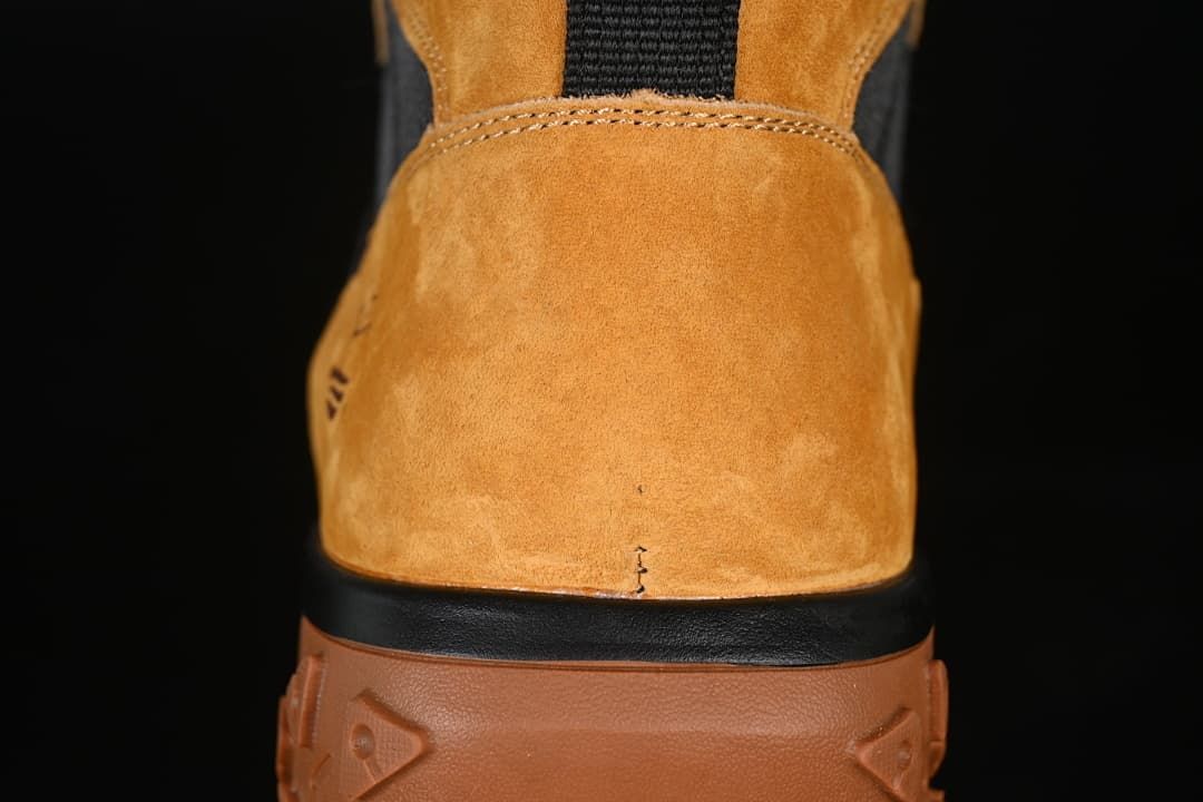 Rear close-up of the wheat-colored boot heel and brown outsole