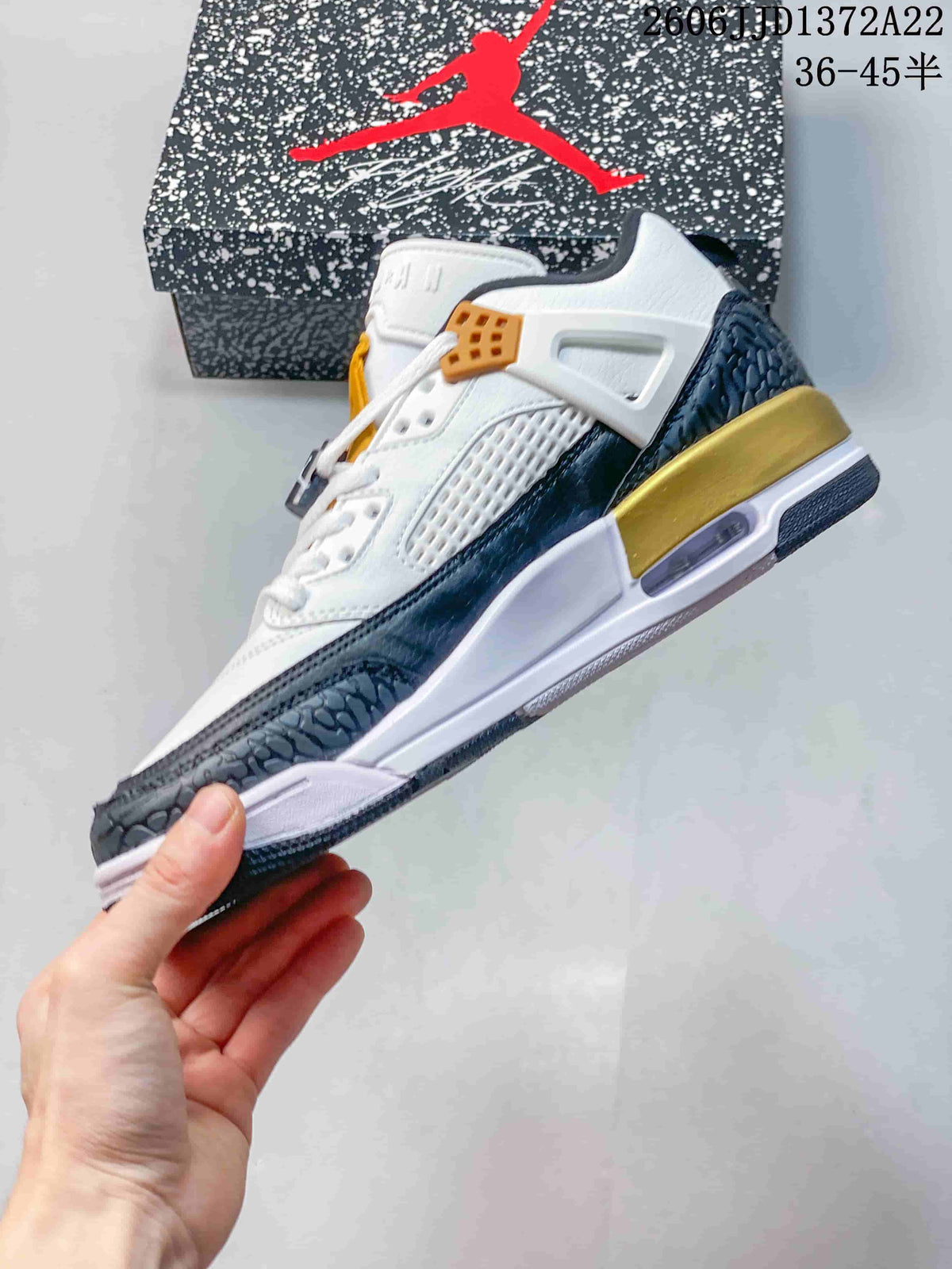 Side view of the low-top sneaker showing layered panels and gold accents