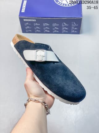 Dark navy suede closed-toe clog with a silver buckle, shown with its branded box.