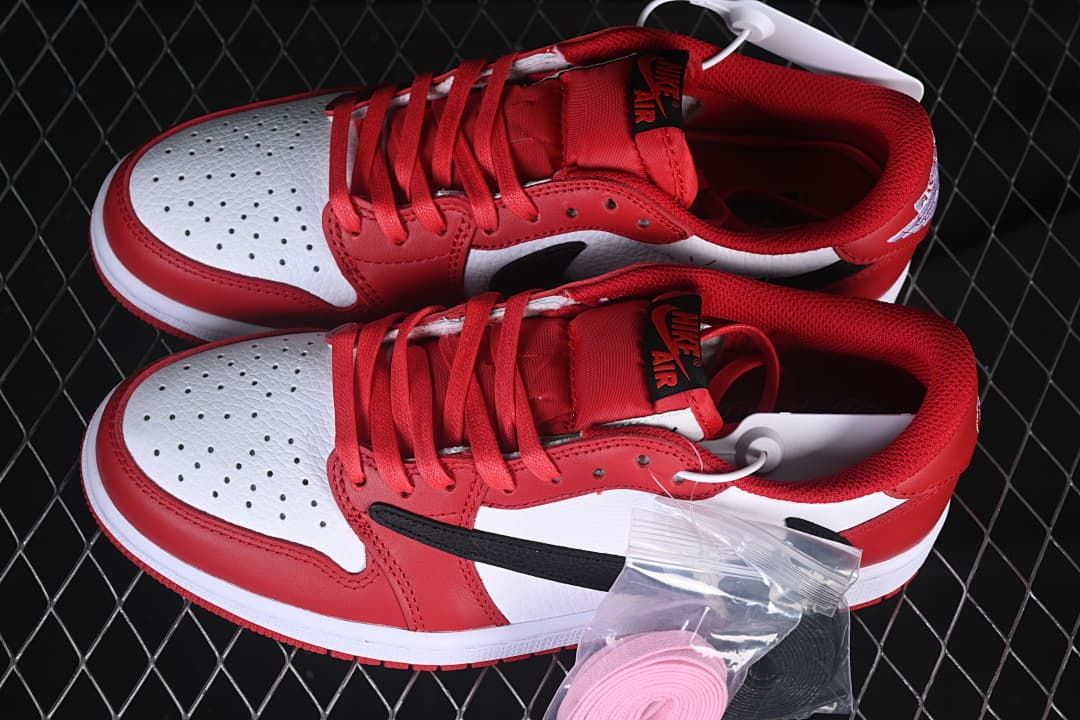 Pair of red, white and black low-top sneakers with extra laces pictured.