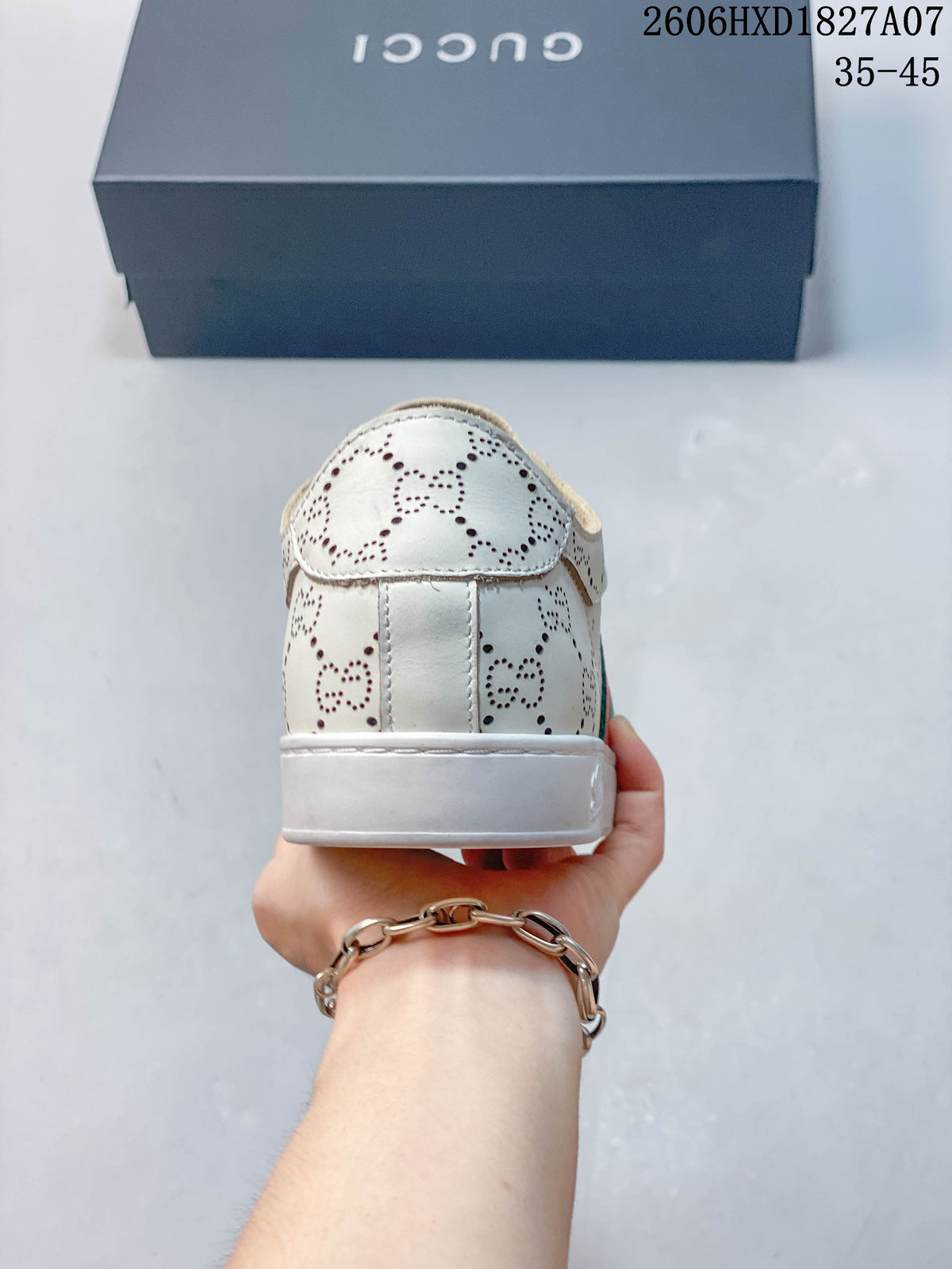 Rear view of white perforated low-top sneaker with a flat white sole