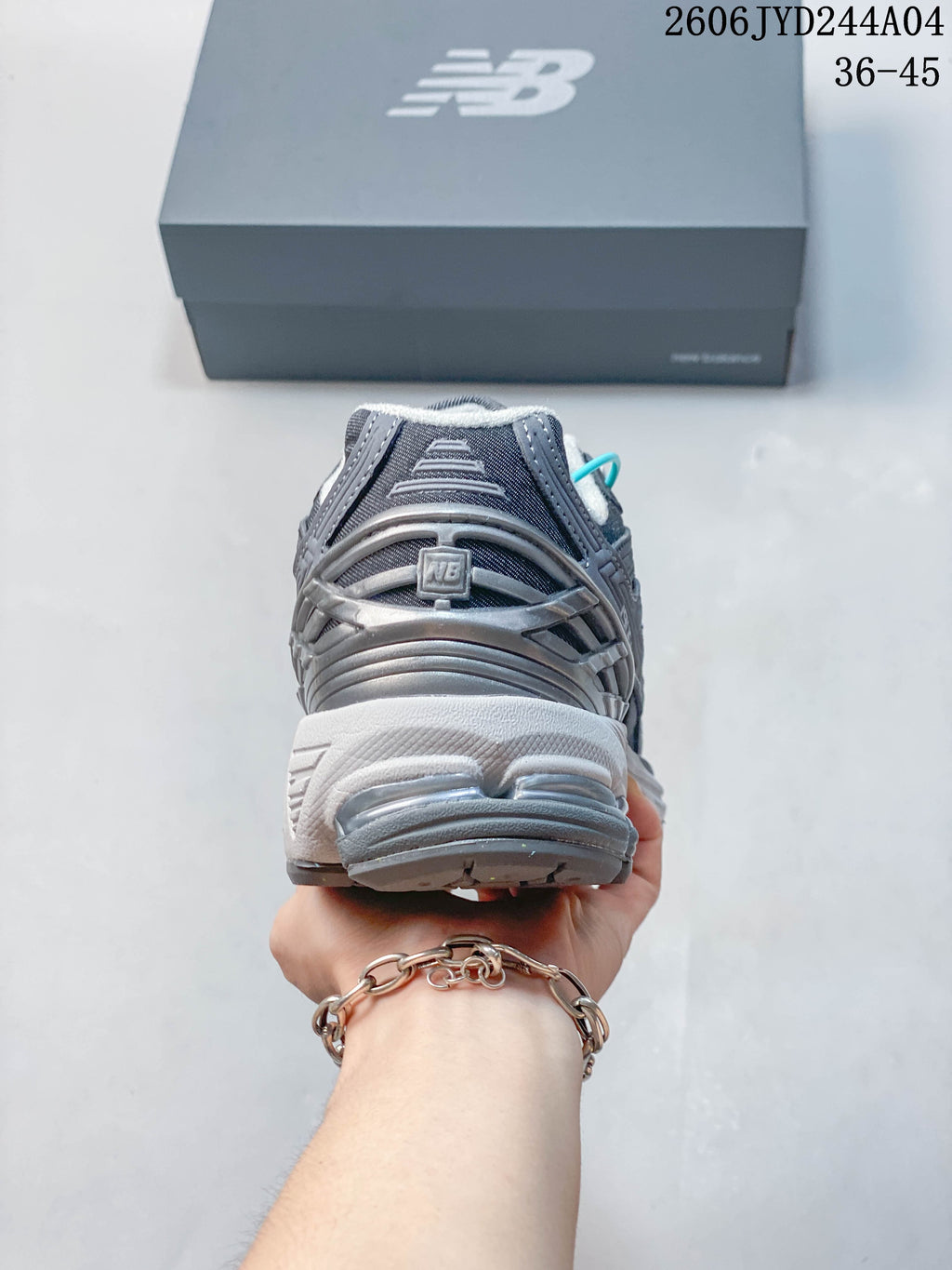 Rear view of a gray New Balance 1906R sneaker