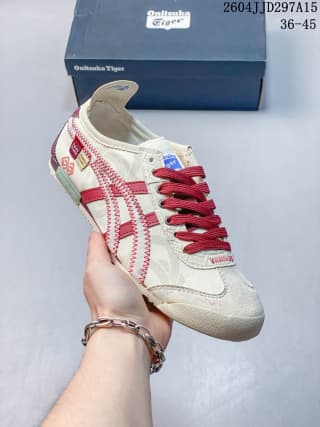 White and red Onitsuka Tiger low-top sneaker shown from the side with a matching branded shoe box behind it.