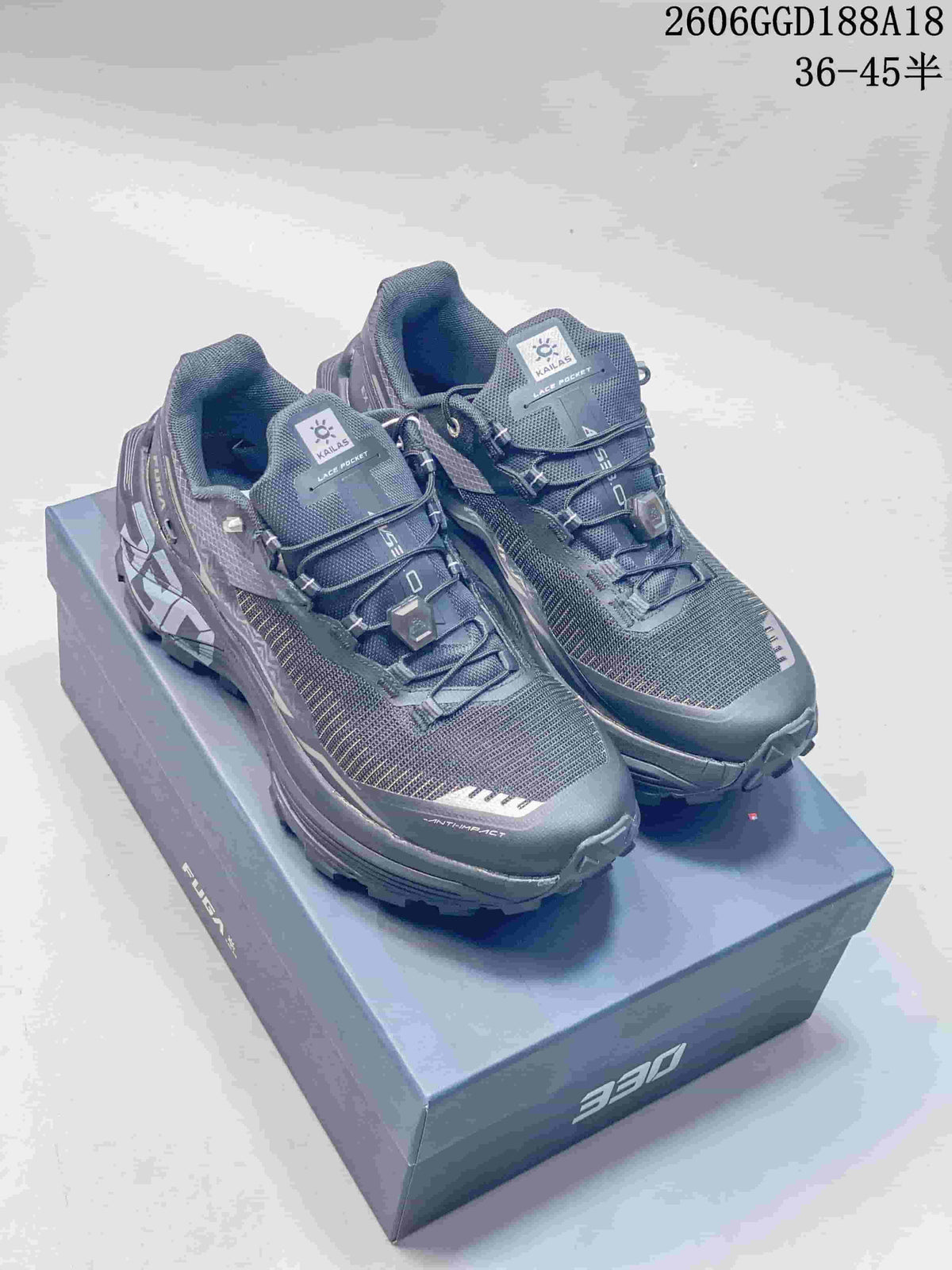 Pair of gray KAILAS FUGA trail running shoes shown from the front on a shoe box