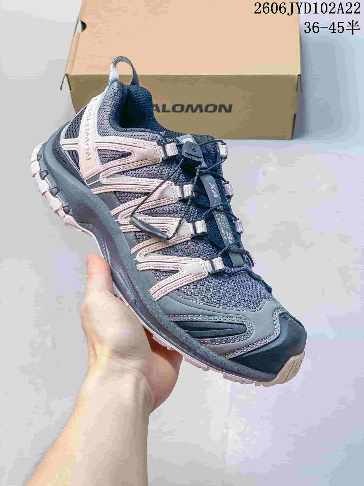 Angled side view of a gray and pale pink Salomon XA Pro 3D shoe