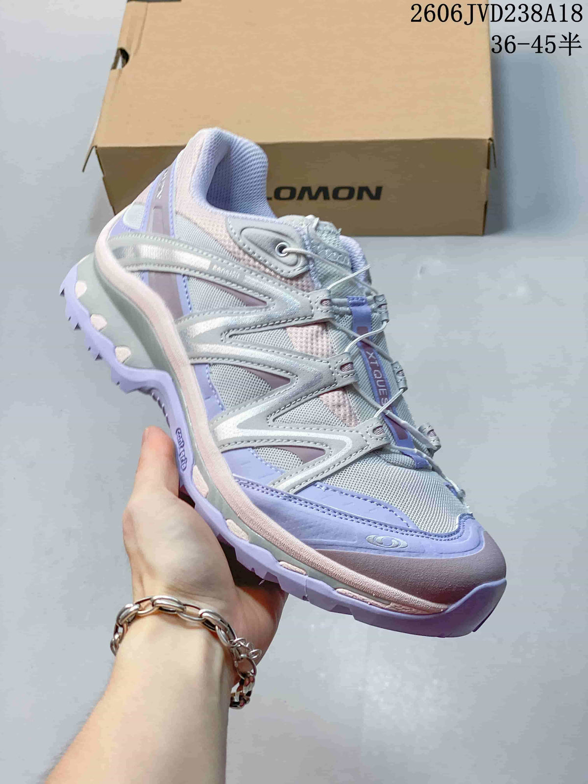 Angled side view of the silver-toned Salomon XT-Quest ATHR sneakers.