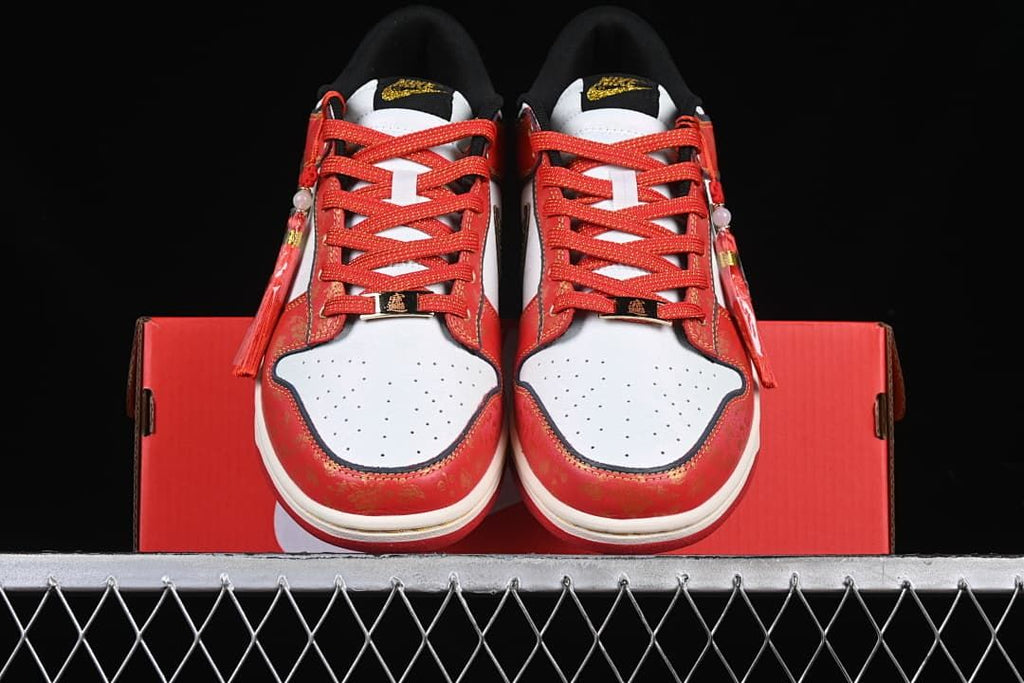 Front view of the pair showing white perforated toe panels and red laces