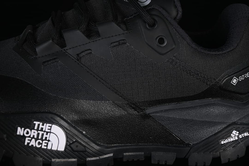 Close-up of lace loops, side panels, and rugged outsole