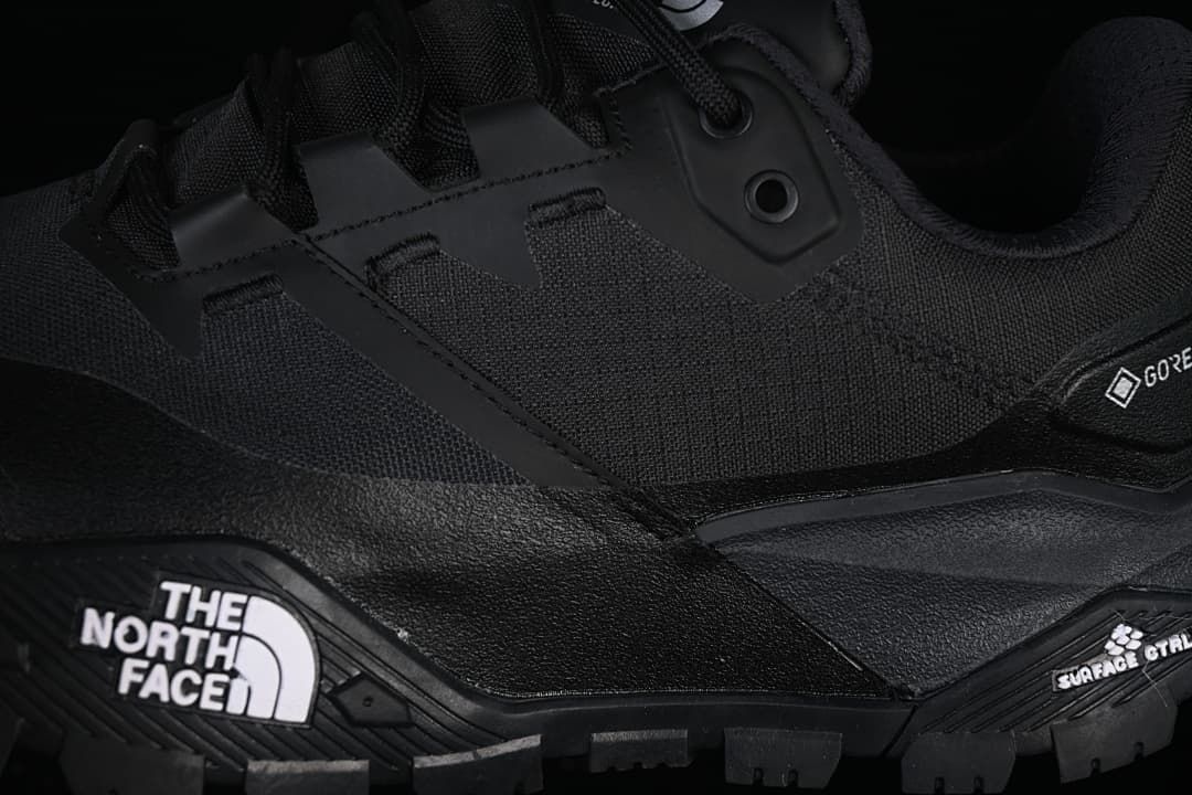 Close-up of lace loops, side panels, and rugged outsole