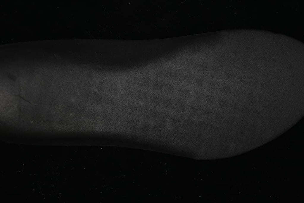 Close-up view of a dark shoe surface