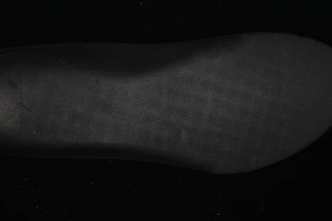 Close-up view of a dark shoe surface