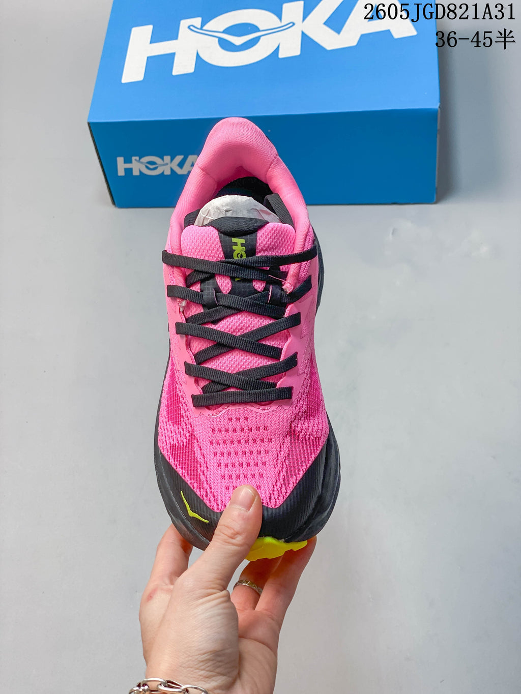 Top view of the pink running shoe showing its mesh-look upper and black laces.