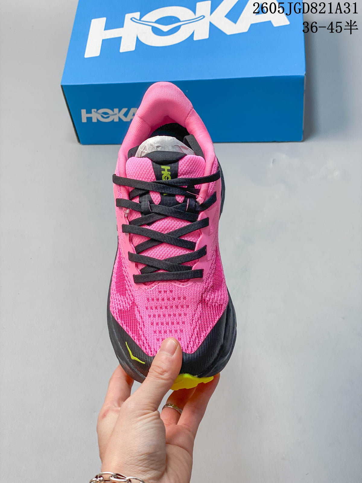 Top view of the pink running shoe showing its mesh-look upper and black laces.