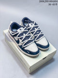 Pair of white and navy blue low-top sneakers with thick white laces, shown on a Nike Dunk box.