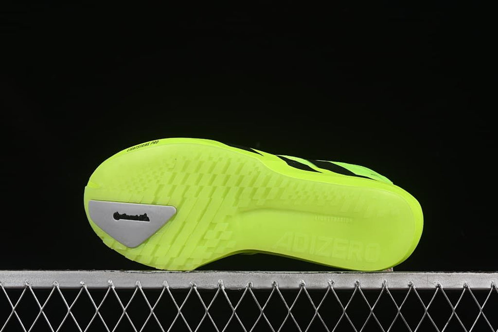 Underside of the shoe showing the neon yellow outsole