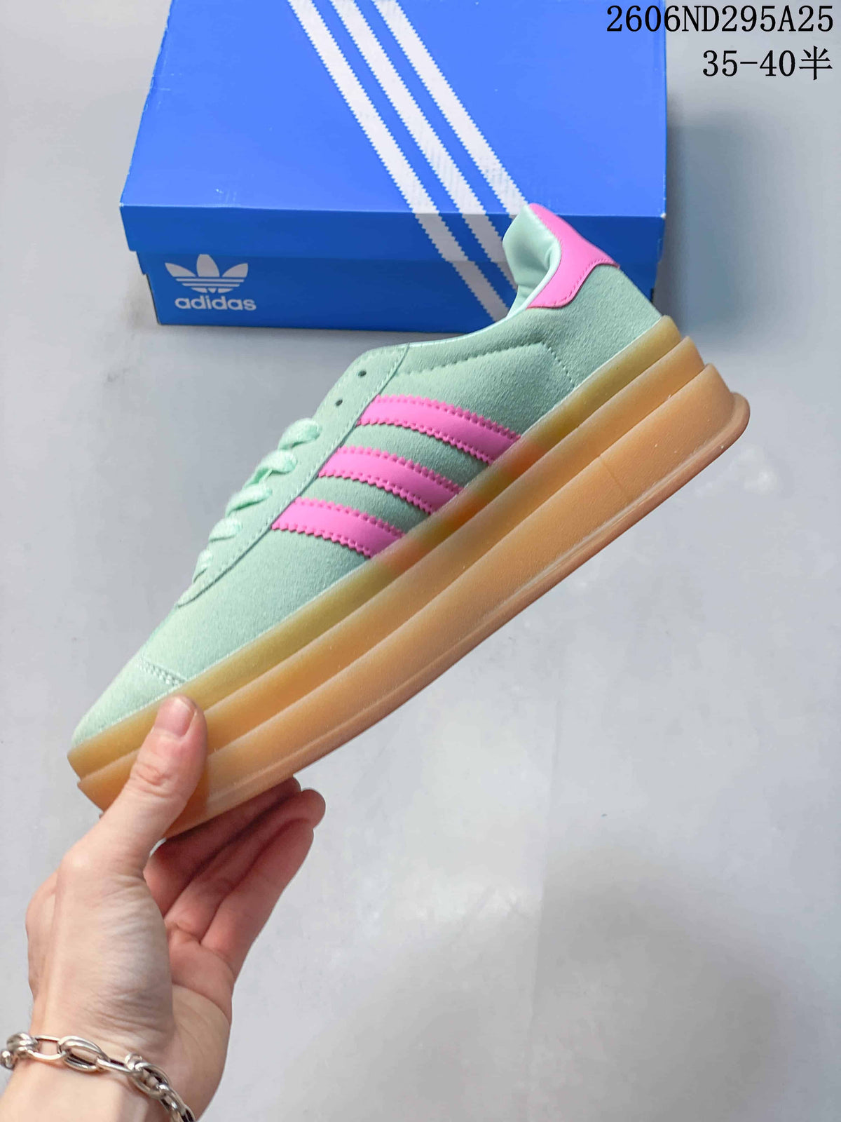 Side profile of the mint-green sneaker with pink stripes and a gum-colored platform sole