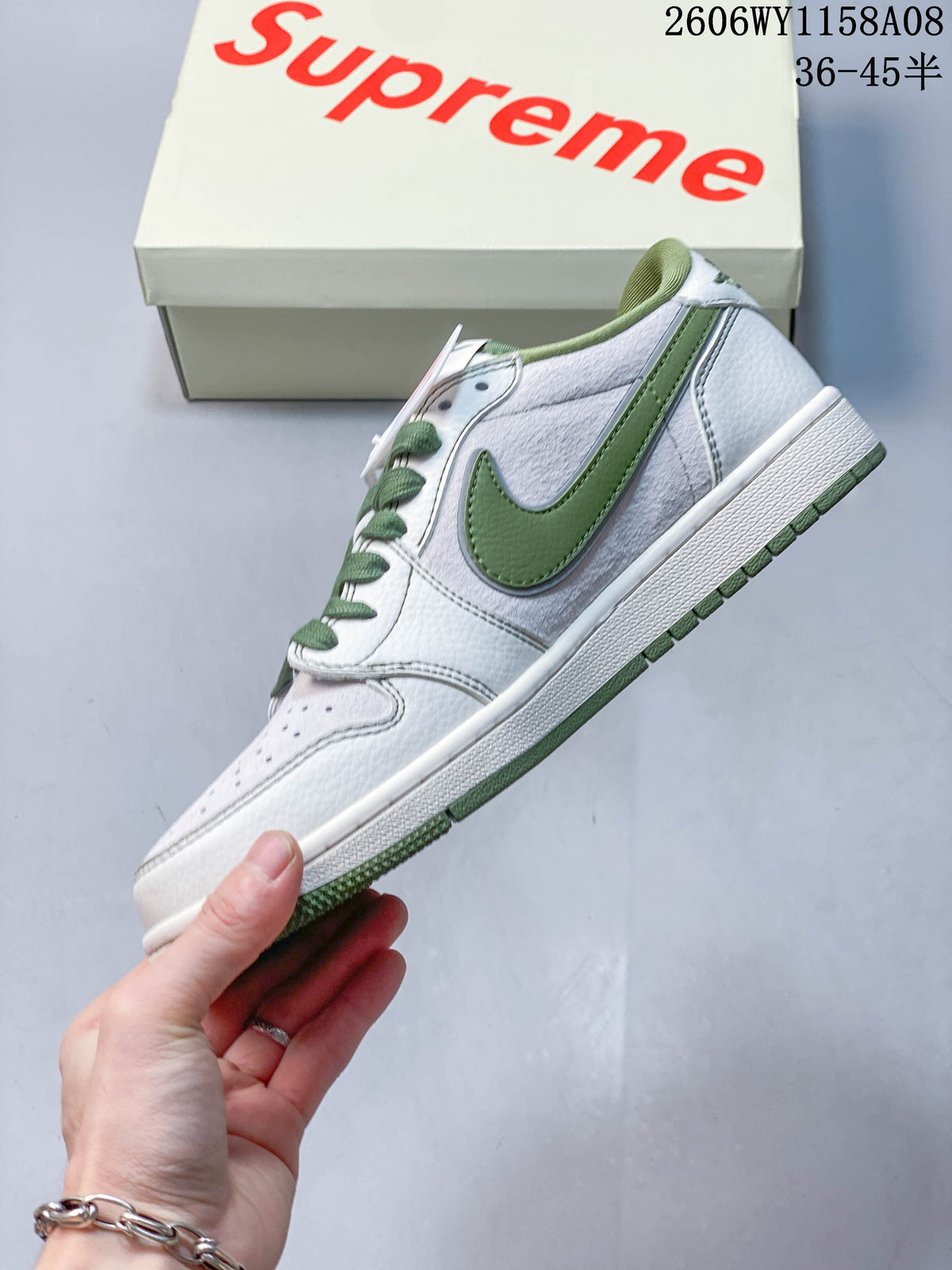 Side view of an off-white low-top sneaker with a green Swoosh