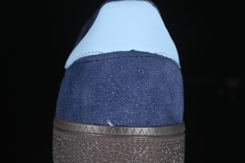 Rear view showing the pale blue heel tab and brown sole