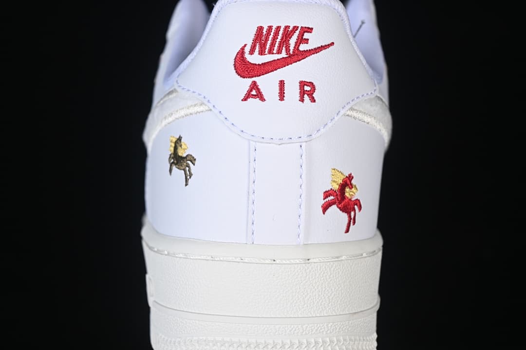 Heel view with red branding and embroidered horse motifs.