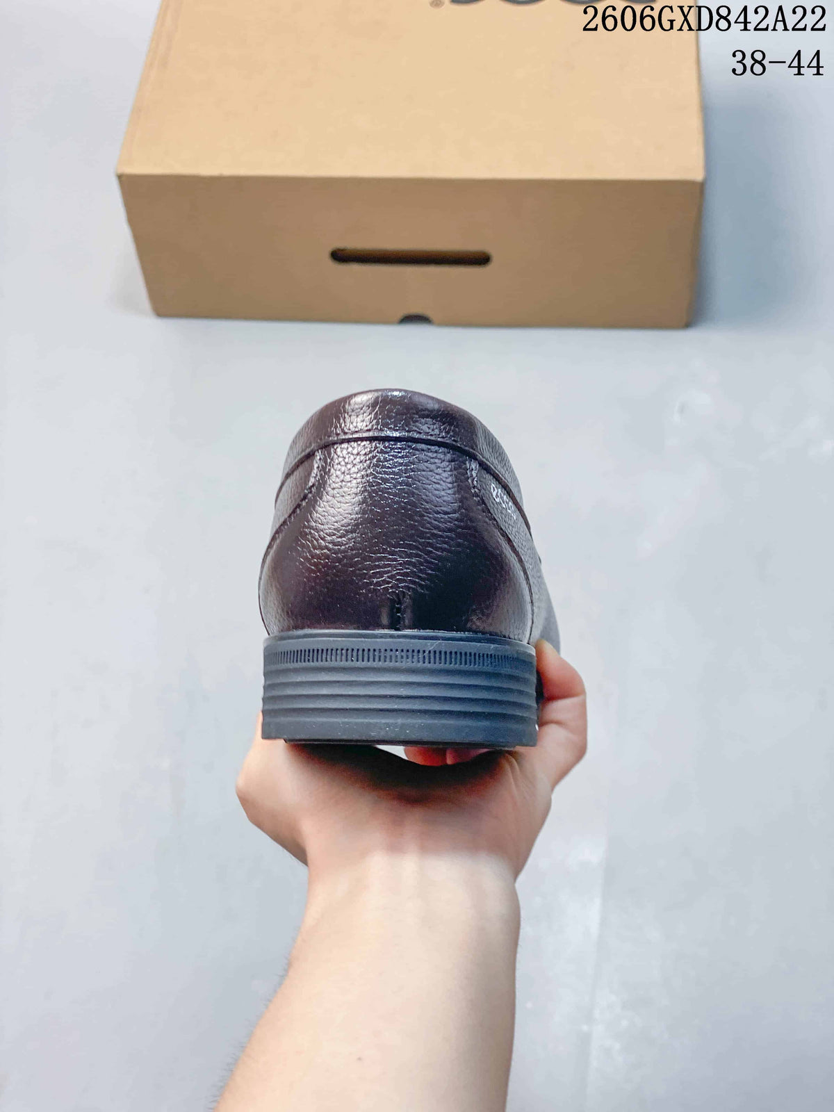 Rear view of a brown loafer with a low dark heel