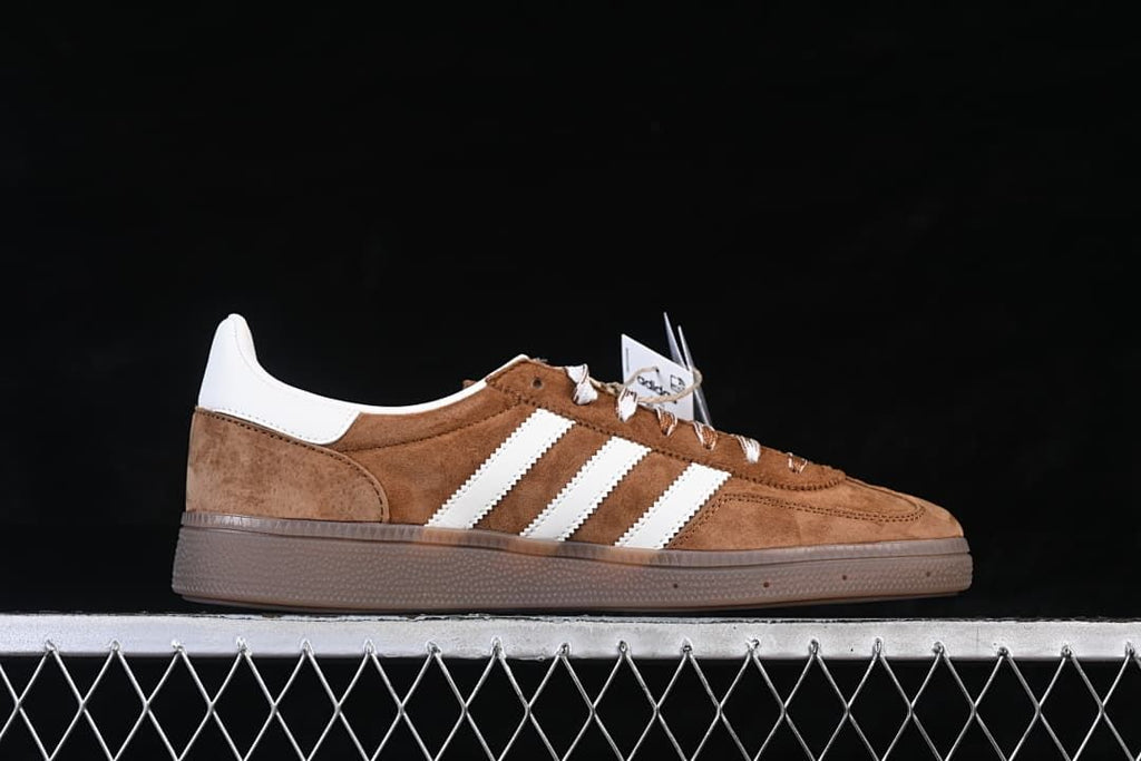 Side profile highlighting the stripes, brown upper, and gum-tone sole