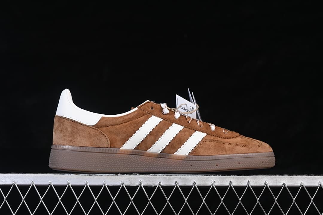 Side profile highlighting the stripes, brown upper, and gum-tone sole