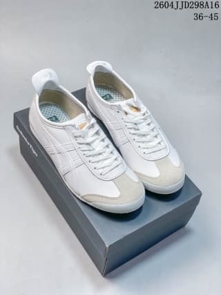 Pair of white and silver ASICS Tiger Mexico 66 sneakers displayed on top of the shoebox.