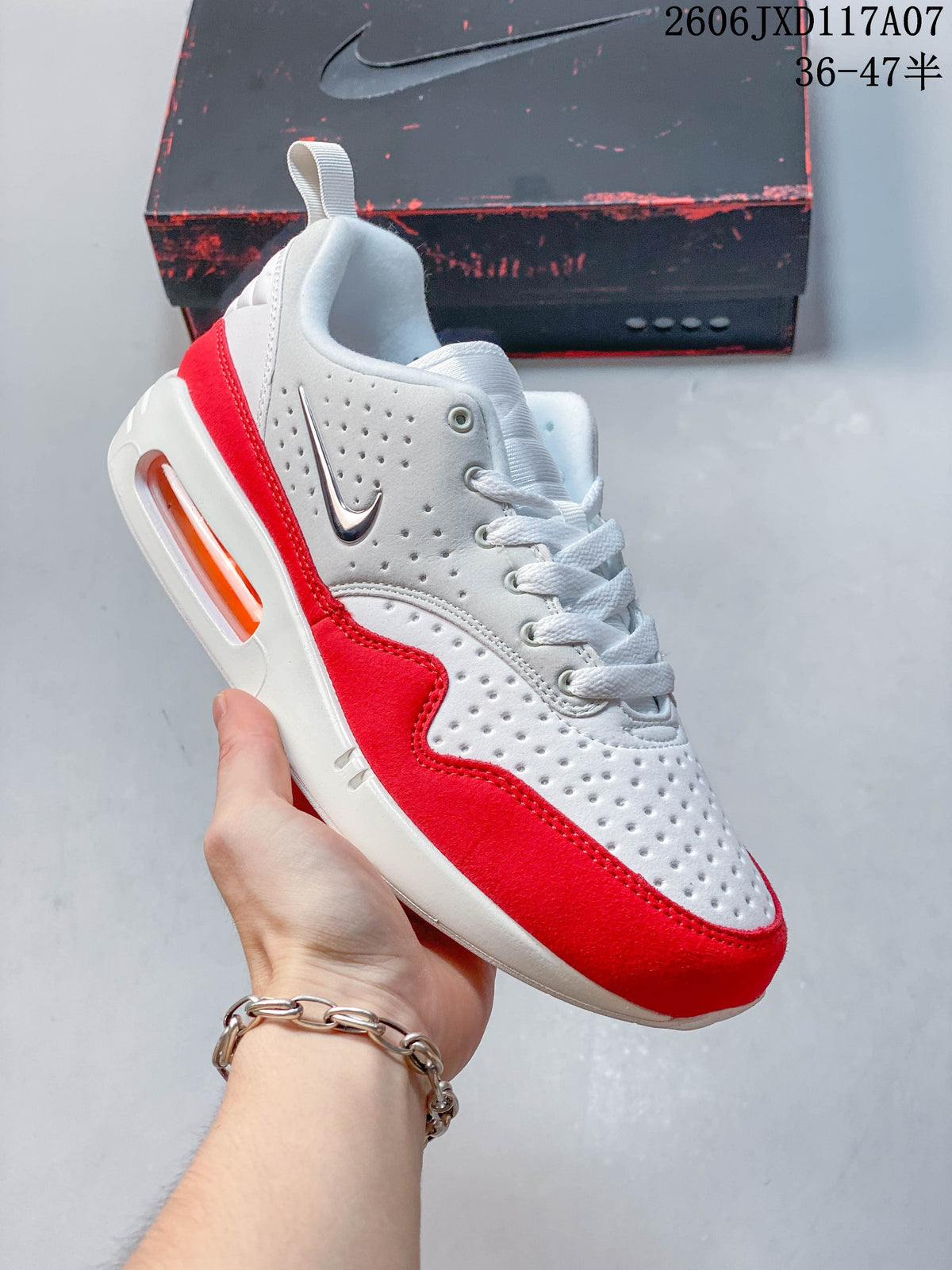 Angled side view of the white and red Nike Air Max 1 sneaker