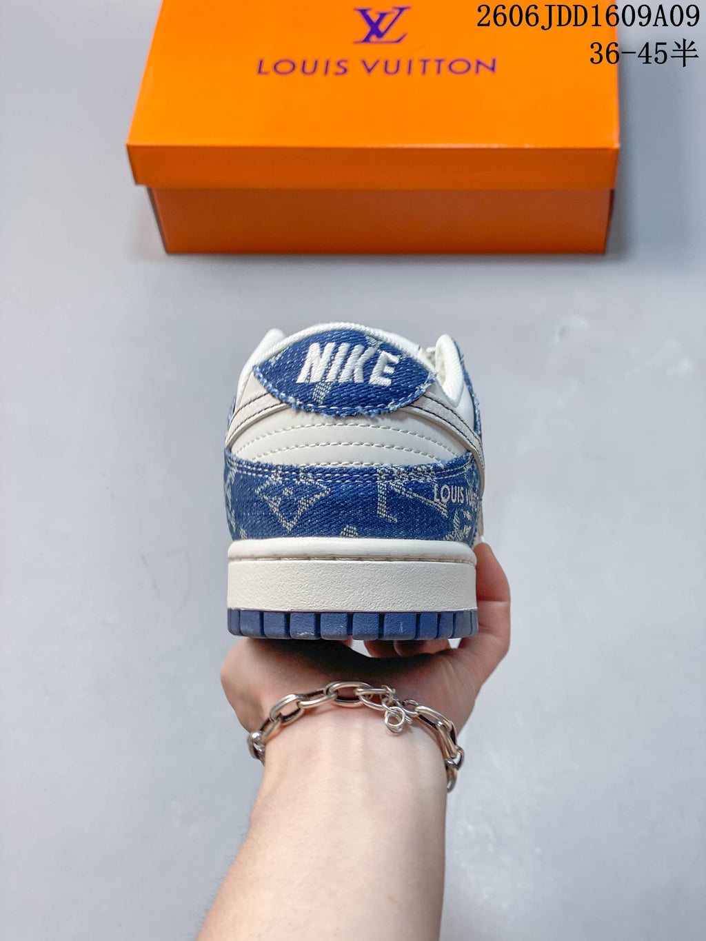 Rear view of the sneaker showing blue denim-print heel panels and cream midsole