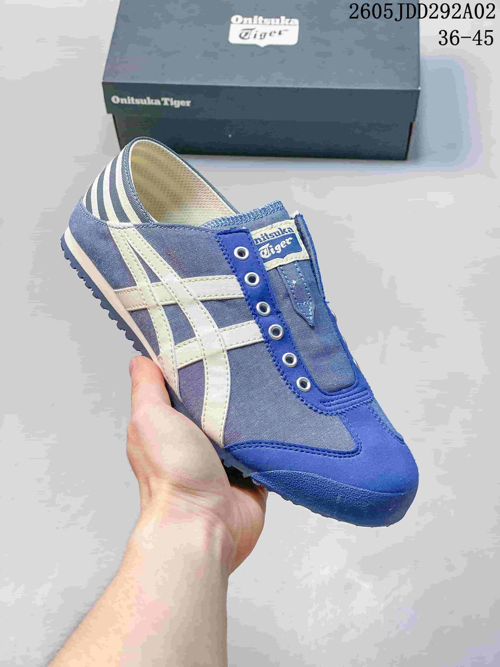 Blue slip-on sneaker with white side stripes and a striped heel panel