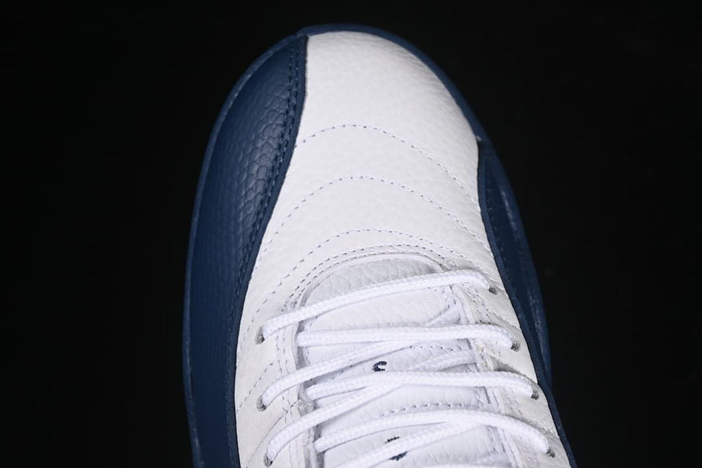 Top view of the white toe and lacing with navy side overlays
