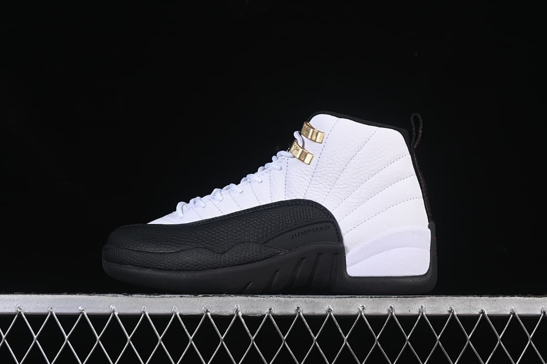 Side profile of the white and black sneaker against a dark background.