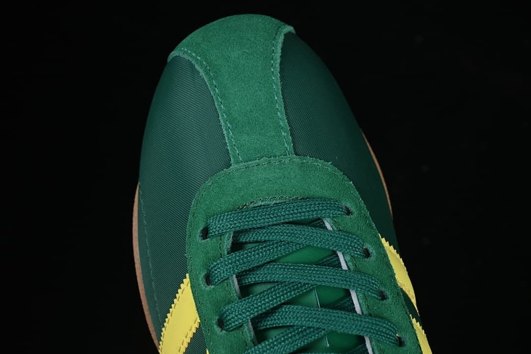 Top view of the green lace-up toe and suede-look overlays