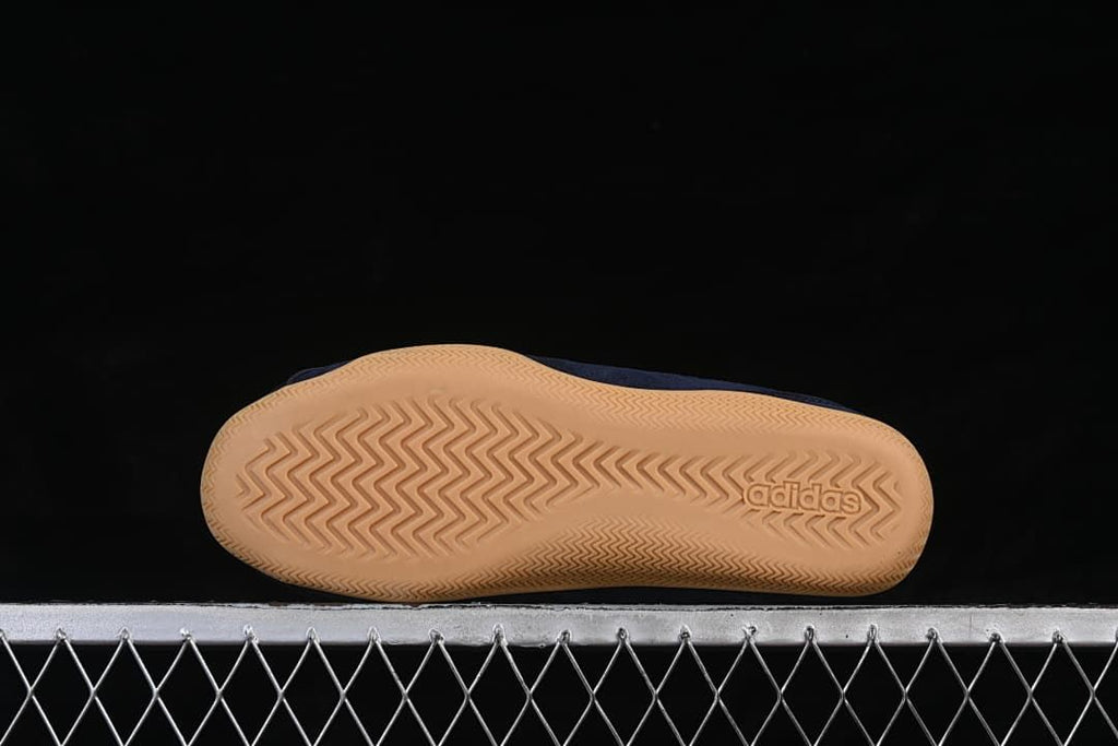 Underside of the gum-colored outsole with a herringbone-style tread pattern.