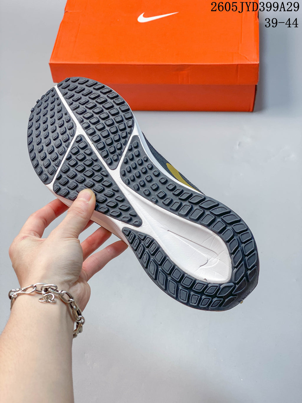 Close-up of the dark outsole and white midsole on a Nike running shoe.