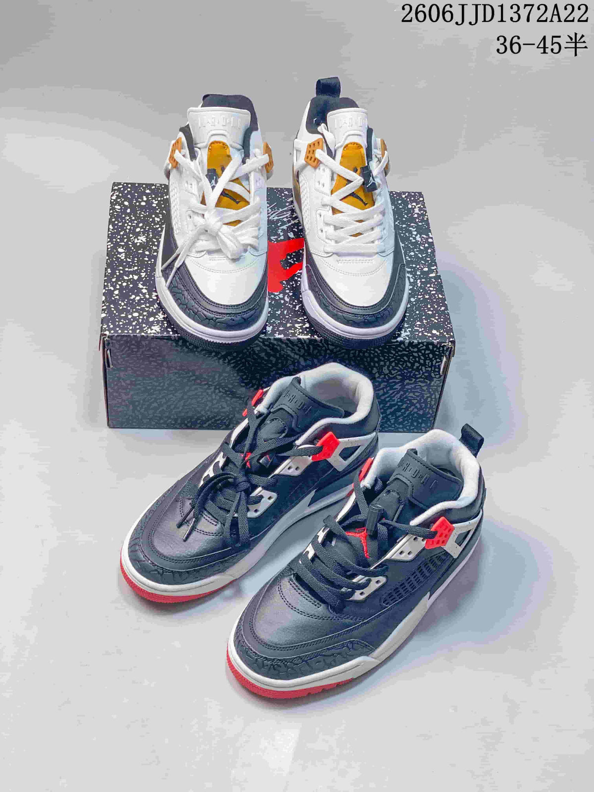White and dark gray Jordan Spizike Low colorways displayed together