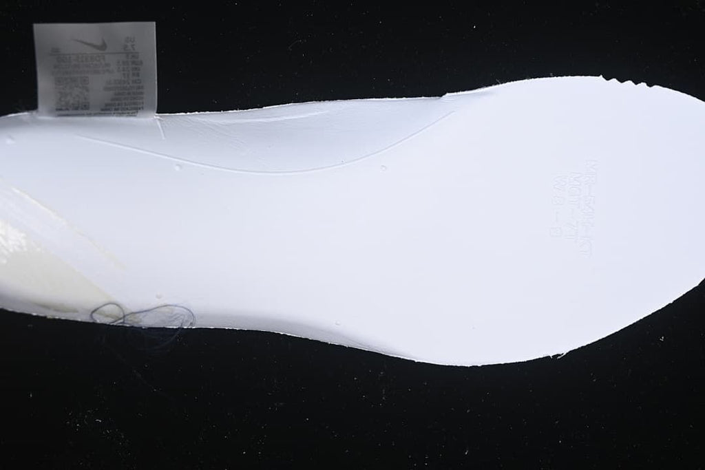 Close-up of the white outsole and an interior shoe label.