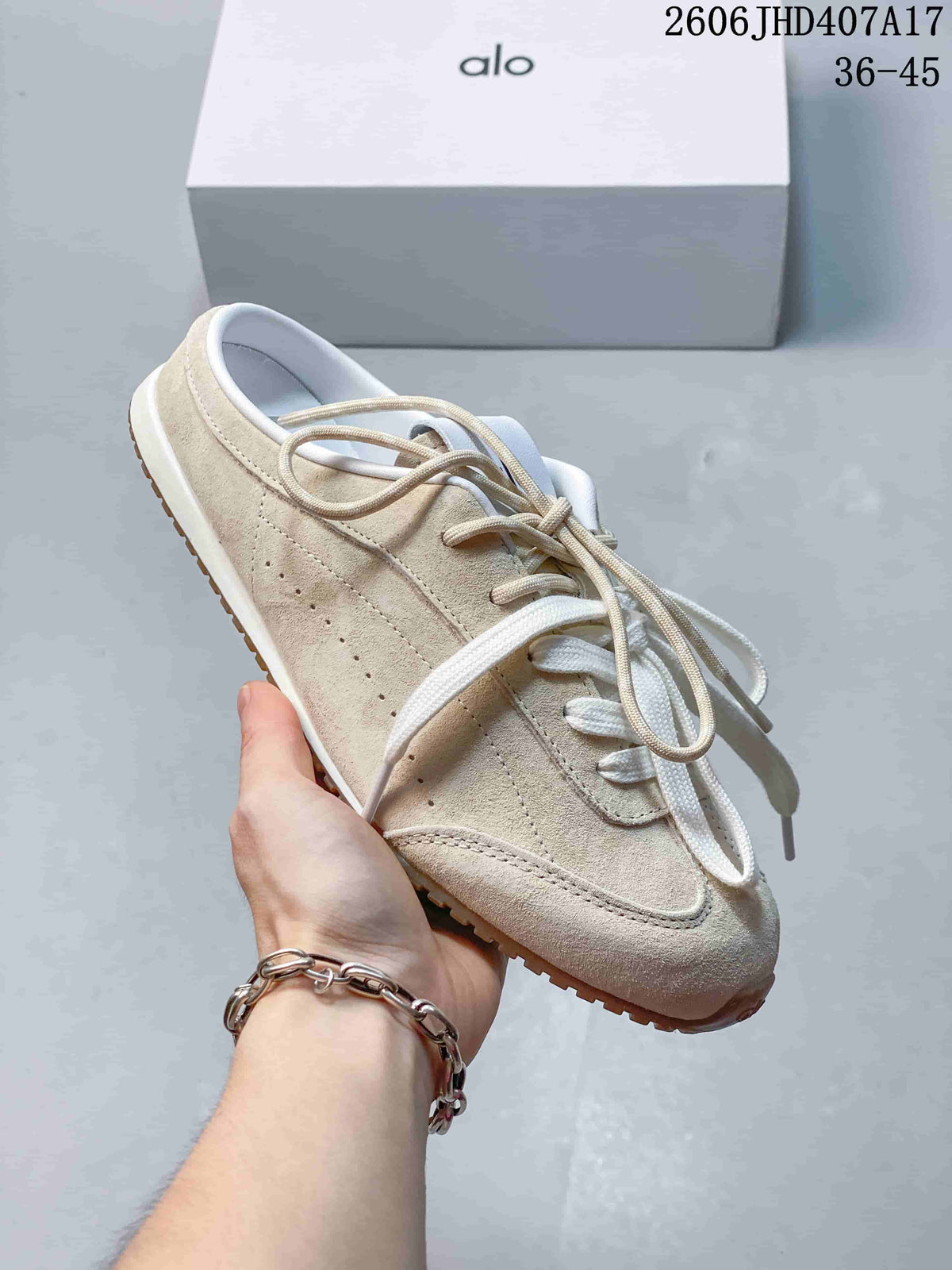 Angled view highlighting the cream upper, side perforations and gum outsole