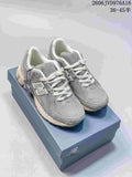 Pair of grey New Balance M1906RKC sneakers displayed on a shoe box.