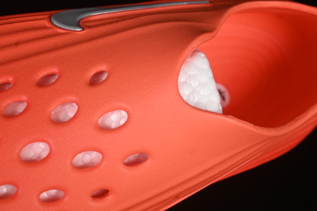 Close-up of the perforated upper and interior of the orange sandal