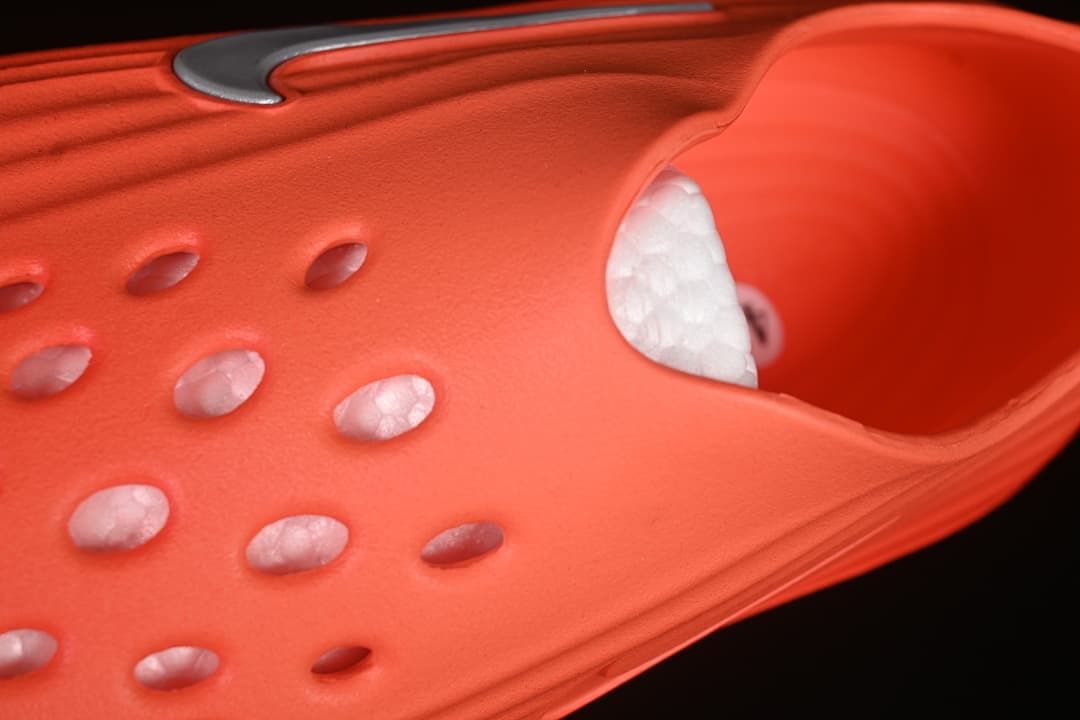 Close-up of the perforated upper and interior of the orange sandal
