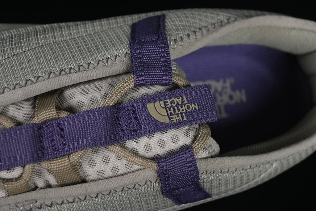 Top detail of the lace-up area and purple webbing.