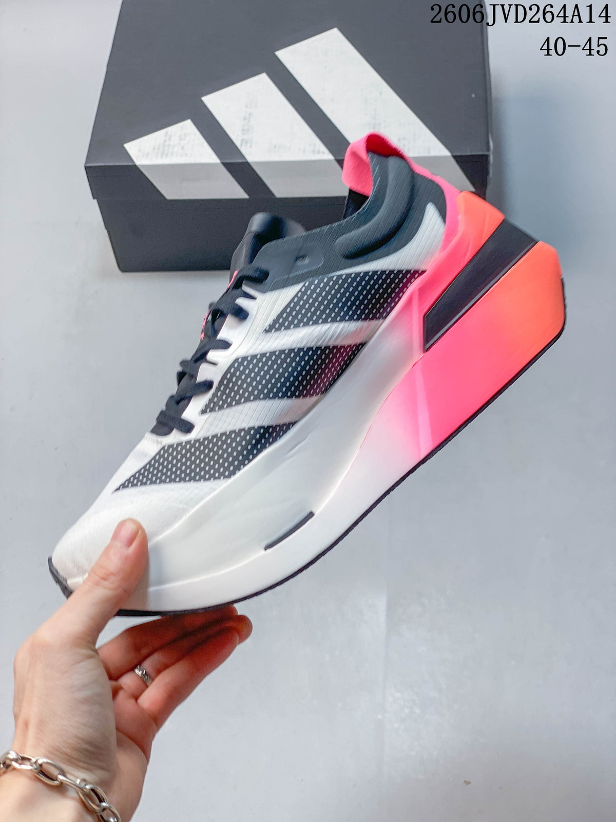 Side view of a white Adidas Dropset Elite shoe with dark geometric panels and a bright accent-colored sole.