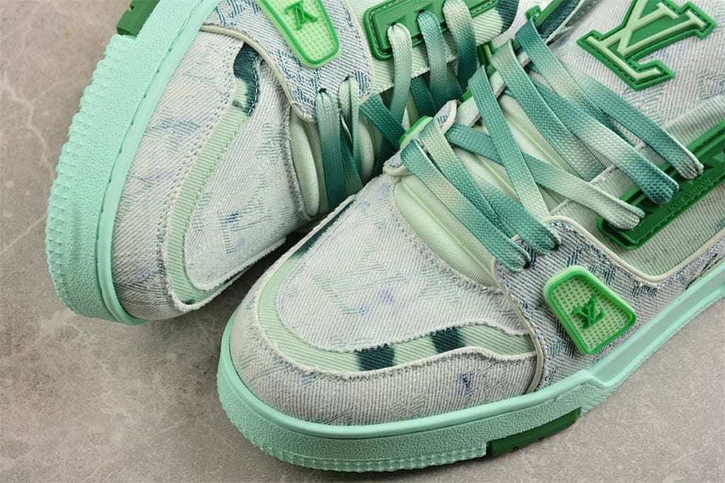 Close-up of the patterned sneaker toe, laces, and green logo-style lace details.