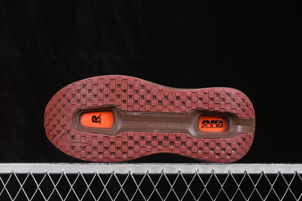 Brown and orange sneaker outsole showing a patterned rubber tread and two visible Air Zoom units.