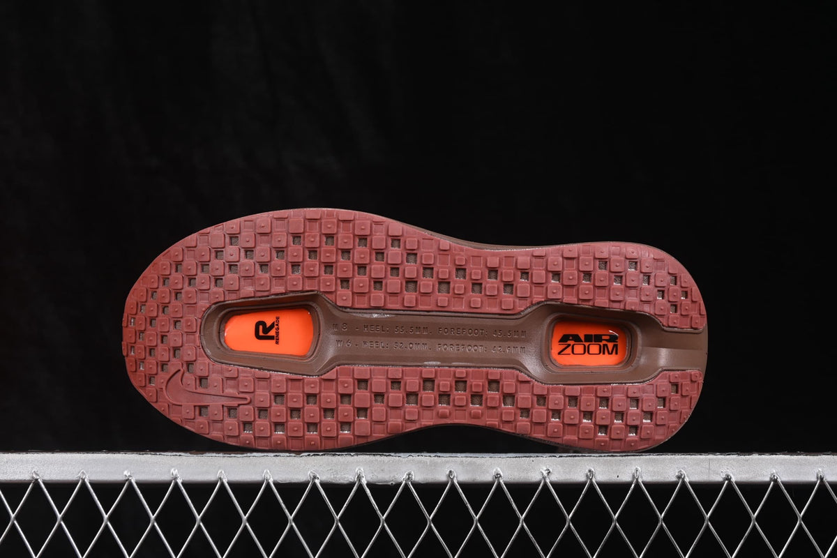 Brown and orange sneaker outsole showing a patterned rubber tread and two visible Air Zoom units.