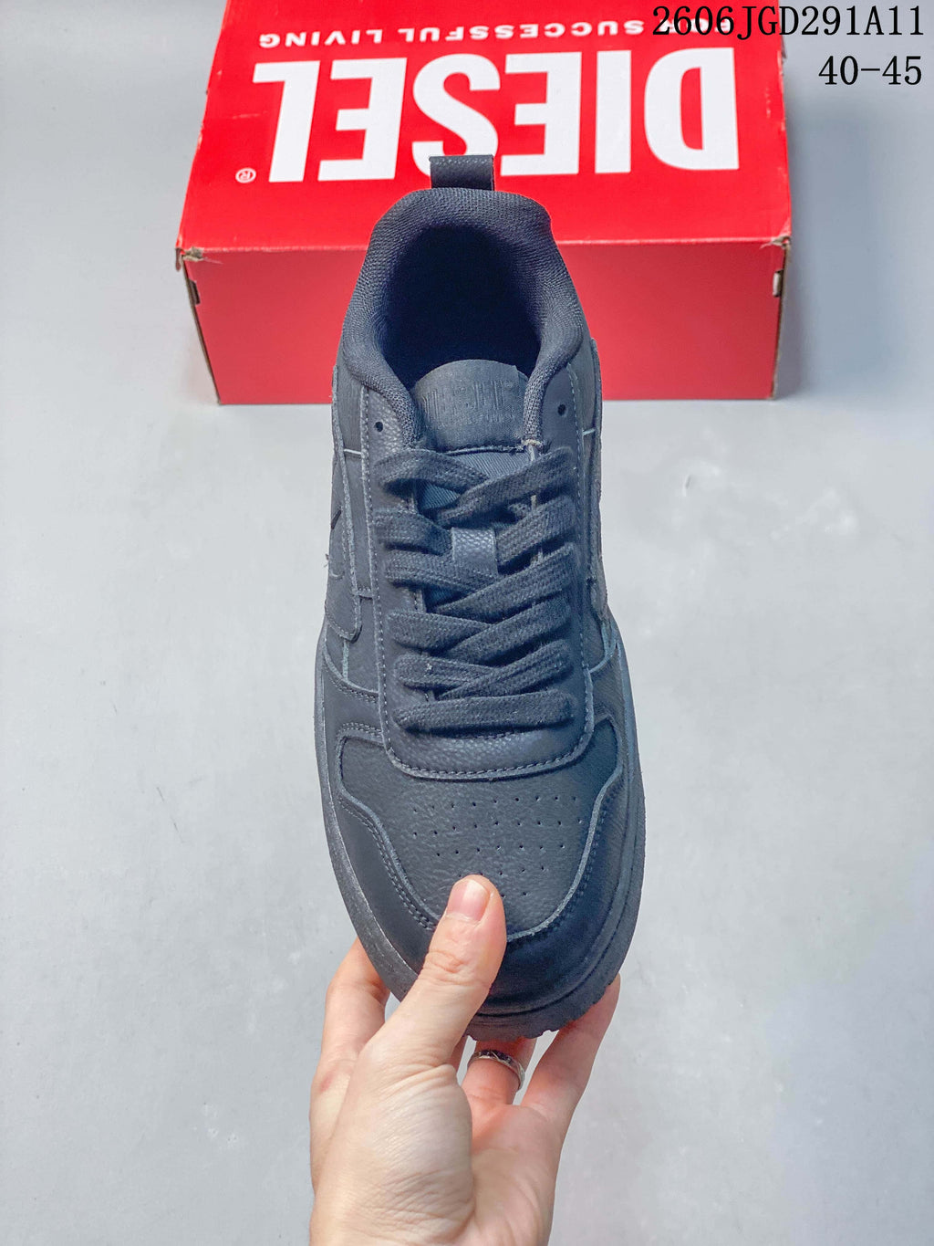 Top view of a dark gray lace-up sneaker with a perforated toe panel